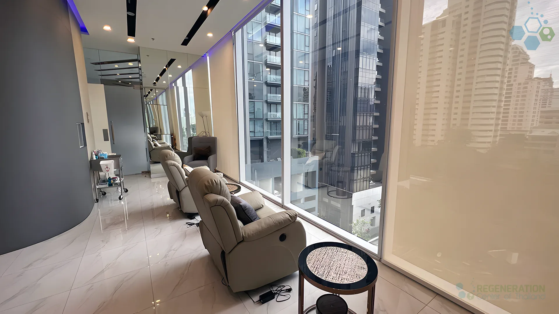 Patient lounge with recliner seating and floor-to-ceiling windows at the Regeneration Center in Bangkok