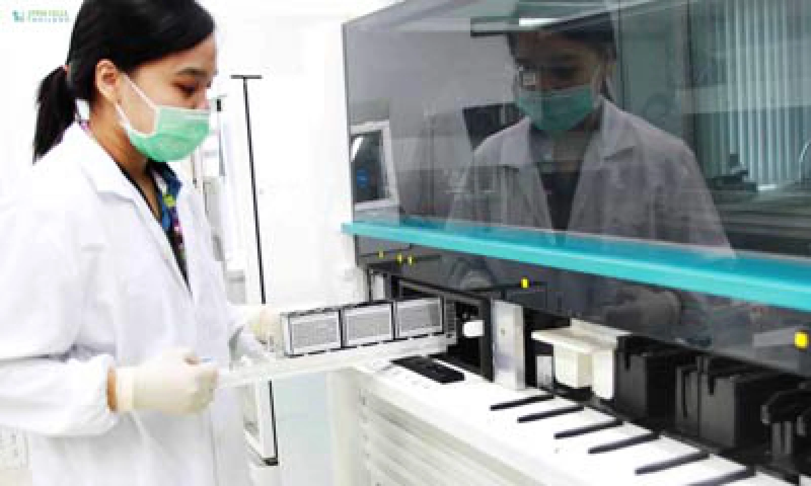 Laboratory scientist operating an automated flow cytometry analyzer