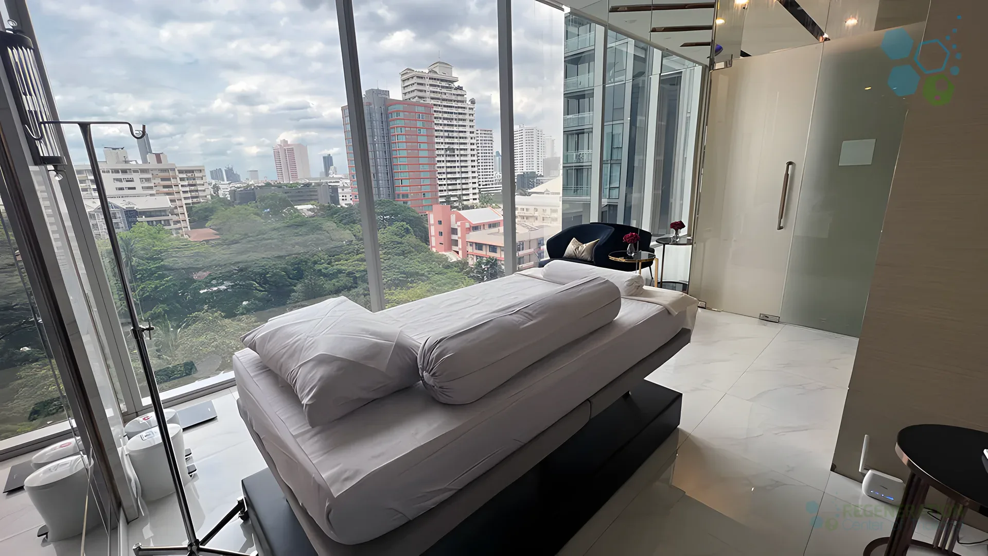 Private treatment room with floor-to-ceiling windows overlooking Bangkok